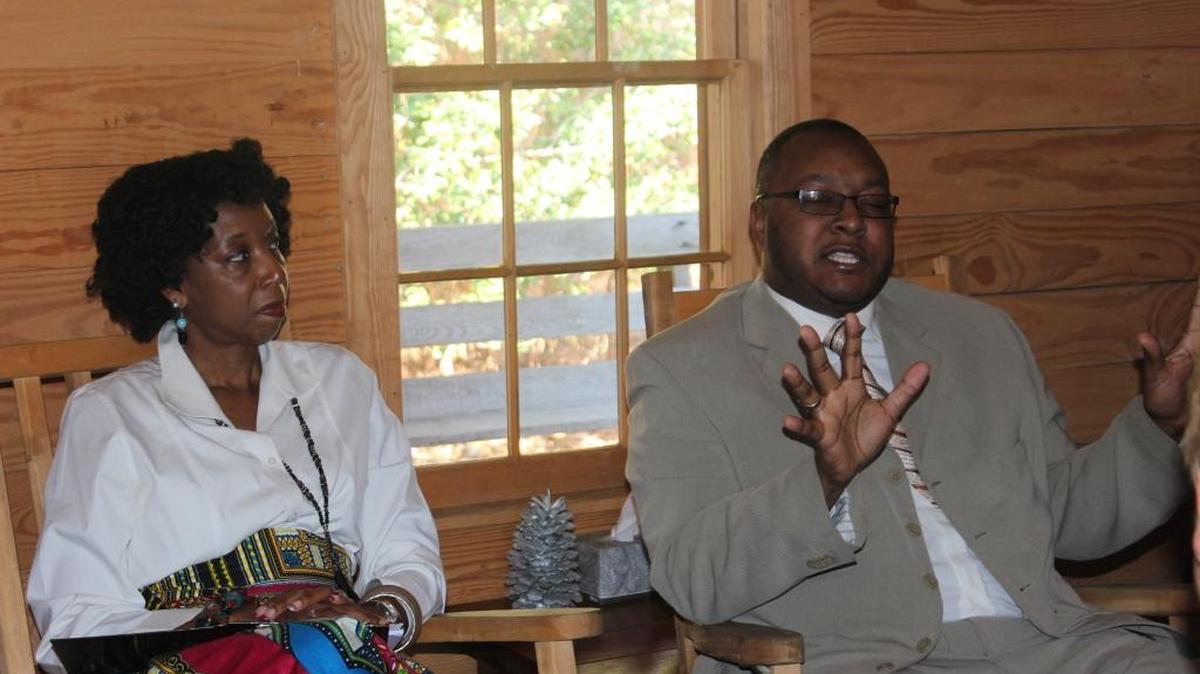 Denise Armor-Brown and John Williams discuss race relations in Horry County Schools to a group of visitors to Freewoods Farm on Saturday.