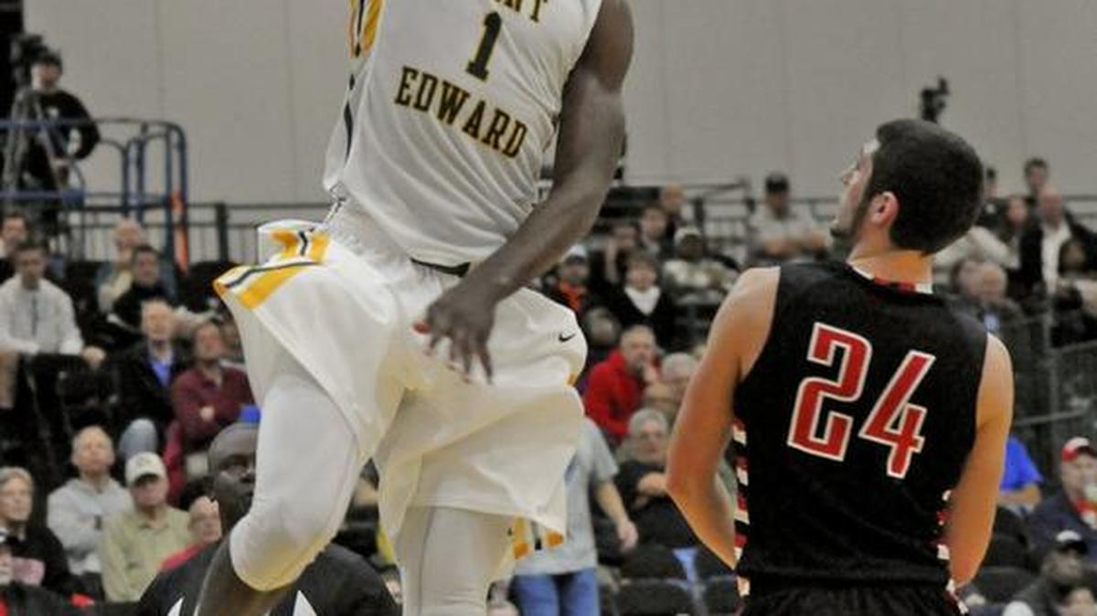 St. Edward’s, Kipper Nichols (left) gets the layup around Franklins’s, Matt Thompson during their Beach Ball Classic game at the Myrtle Beach Convention Center in this file photo from 2014.