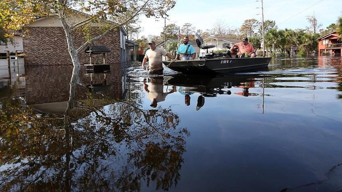 People use boats and friends to help collect pets, food and belongings as they evacuate their homes during the flood in the Rosewood community of Socastee on Saturday, Oct. 15, 2016, one week after Hurricane Matthew hit. A section of the community was under evacuation on Saturday as the water continued to rise. The Waccamaw River feeds into the Intracoastal Waterway south of the community.