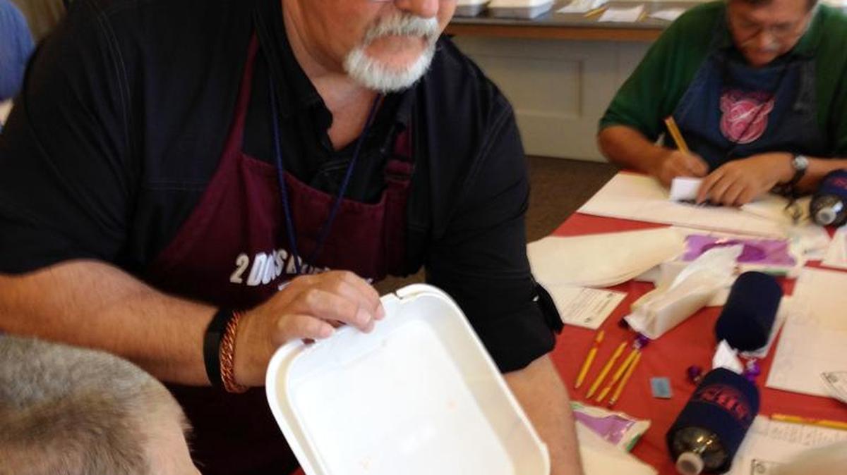 Andy Gillentine is a Table Captain and is displaying a sample box of BBQ at this year’s Pork in the Park contest in Newberry, S.C.