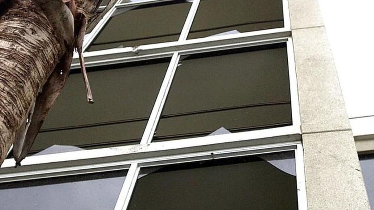 Megan Greer of Spartanburg looks out a tower of broken windows at the Sandy Beach Resort on Ocean Boulevard shortly after a tornado touched down in Myrtle Beach on Friday, July 6, 2001. Janet Blackmon Morgan/The Sun News