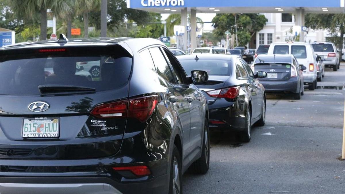 Motorists wait in a line of cars to buy gas at a Chevron gasoline station, Wednesday, Oct. 5, 2016, in Hollywood, Fla. Hurricane Matthew marched toward Florida, Georgia and the Carolinas and nearly 2 million people along the coast were urged to evacuate their homes that Wednesday. (AP Photo/Wilfredo Lee)