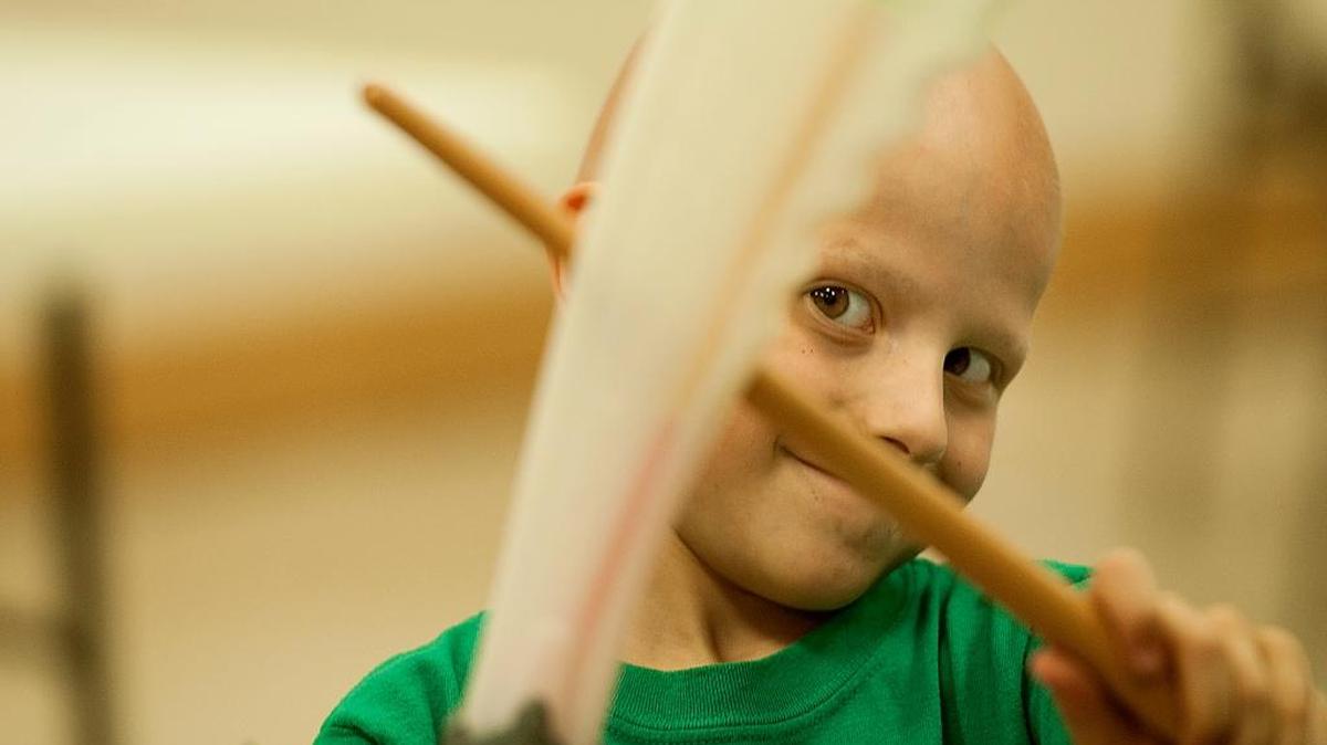 Kaleb Batts plays with a sword and wand he was gifted at Jason's House. Jason's House brings in cancer patients each year for a free vacation at the beach.