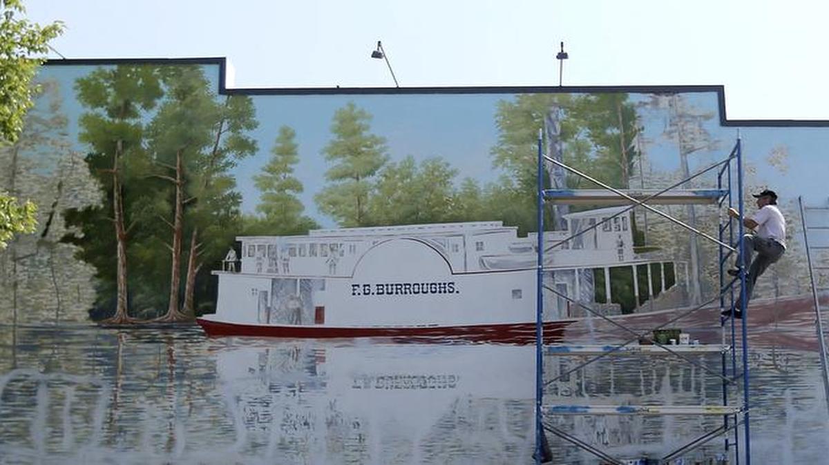 
Tommy Simpson repaints the mural off Conway's Main Street
