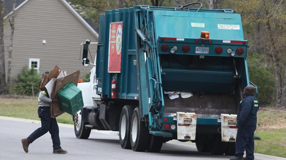 Terry Bessent (right) and Tommy Bell of the Horry County Solid Waste Authority collect recyclables.