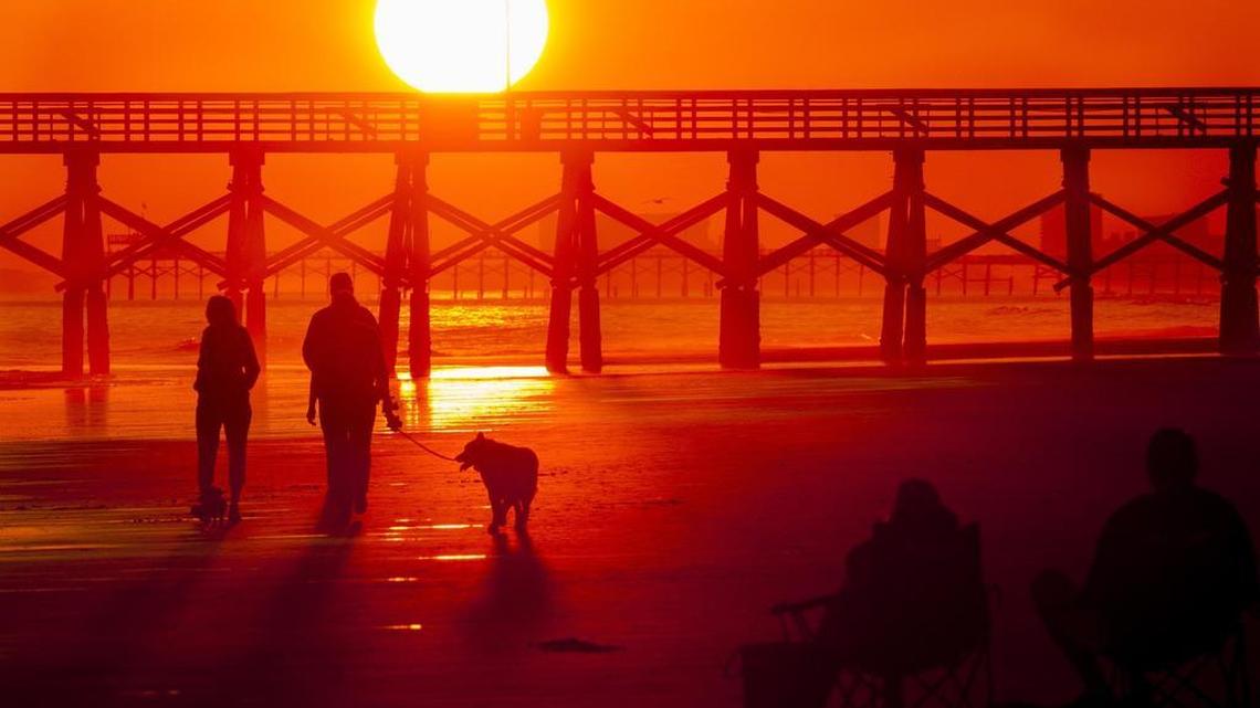 Beachgoers enjoy a November sunset in the Cherry Grove section of North Myrtle Beach on Friday, Nov. 18, 2016.