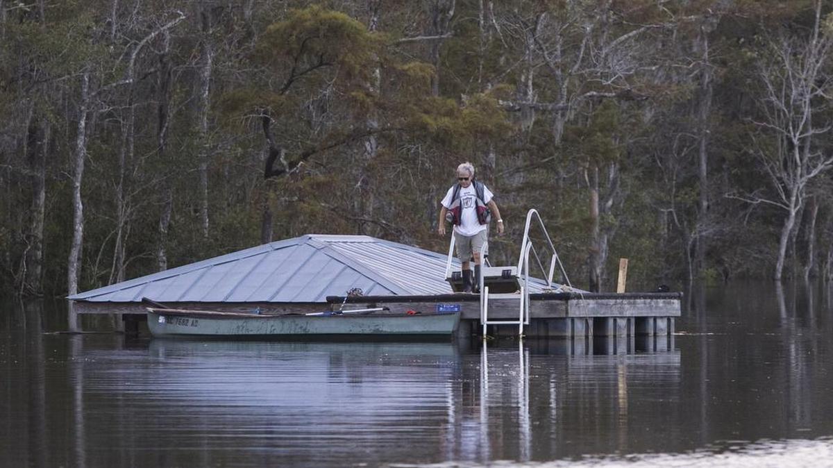 A man check looks at his flooded boat house from a floating dock on the Waccamaw River near Bucksport. 
The Waccamaw River at Conway crested Wednesday at well over 21 feet flooding many downtown homes. Wednesday, Sept. 26, 2018.