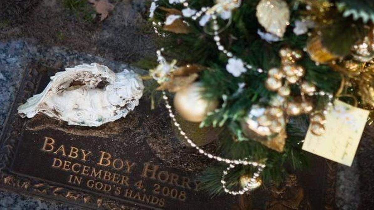 
Rev. Wayne Brown and county Coroner Robert Edge remember “Baby Boy Horry” at Hillcrest Cemetery in Conway. The child, who was found dead in a shopping bag in a wooded area in 2008, was just days old when he was left to the elements.

