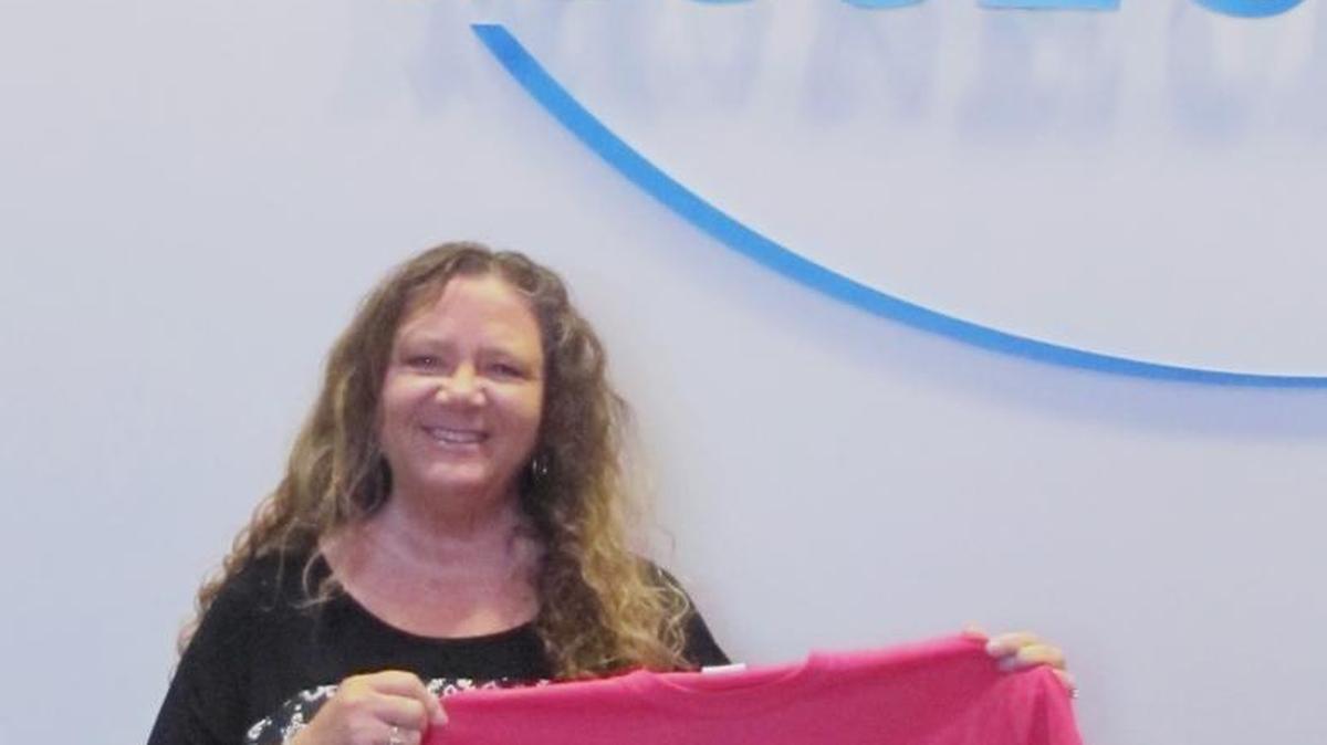 Cathy Altman, executive director of North Myrtle Beach Area Historical Society, displays a T-shirt former museum executive director Jenean Todd designed specifically for sale in the museum. Old window frames with stained glass and christening gowns will be additions to the gift shop for purchase.