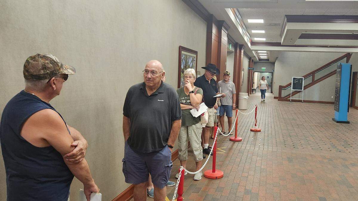 People chat in line while waiting to speak with Horry County tax assessors on Oct. 6, 2023 as annual bills began arriving.