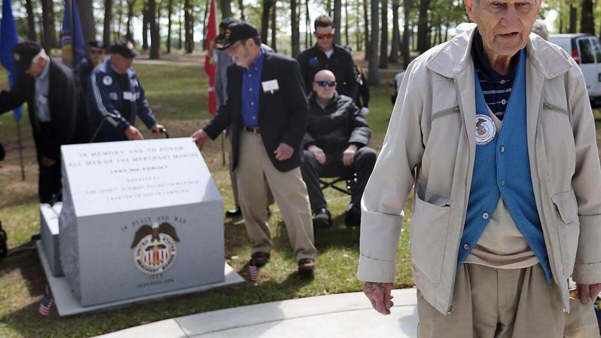 Ralph Ashby (right) is 102 years old. He served as a Merchant Mariner in World War II. The Little River resident attends the unveiling of the John T. Schmidt Palmetto Mariners Chapter American Merchant Marines Veterans monument on Friday, April 8, 2016, at Warbird Park near The Market Common. “In memory and to honor all the men of the Merchant Marine. Lest we forget. Donated by the John T. Schmidt Palmetto Mariners Chapter of South Carolina,” is etched on the granite top.