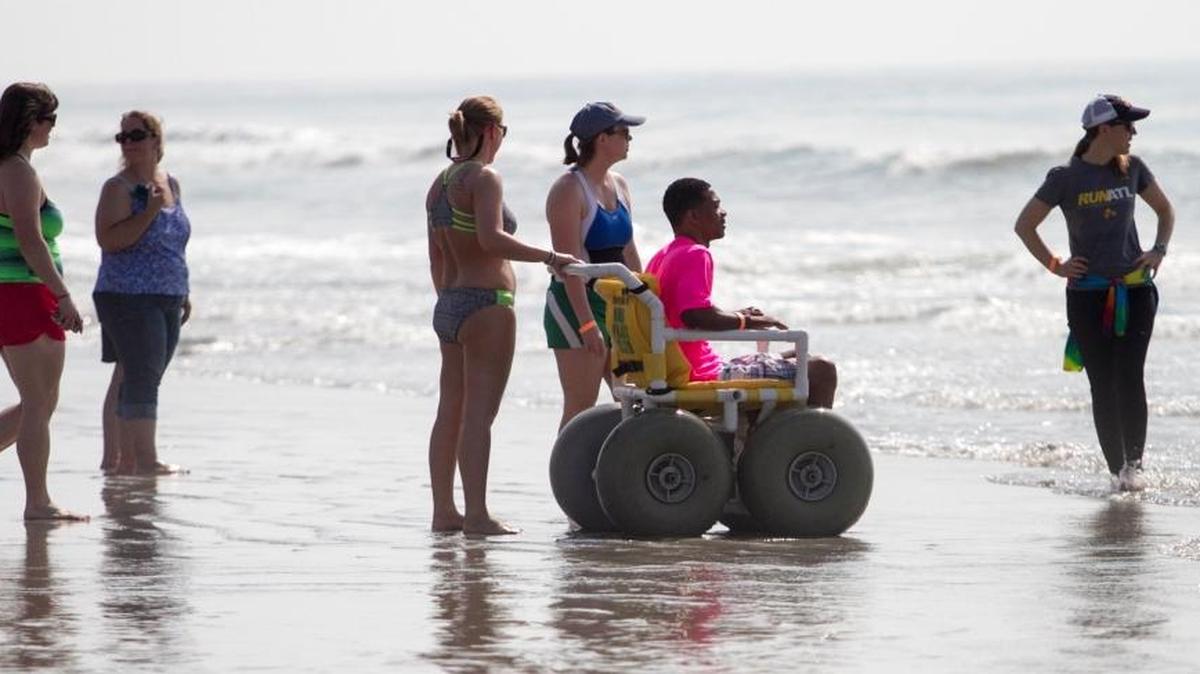 A surfer waits in a beach wheel chair for a chance to hit the waves at the “Wheel to Surf” Adaptive Surfing Clinic held in North Myrtle Beach. Forty participants with mental and physical disabilities took to the water with help from over 100 volunteers. "Today is a life changing experience for most of us," said Brock Johnson, founder of “Wheel to Surf.” The clinic was hosted with support from Coastal Adaptive Sports, Ocean-Cure and the Adaptive Sports Project.
