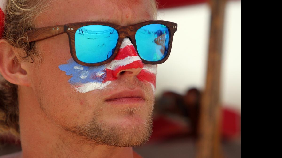 
Luke McGowan, a lifeguard at Coligny Beach, watches swimmers on Saturday afternoon at Coligny Beach Park on Hilton Head Island. Sticking with tradition, McGowan and several of his fellow lifeguards paint American flags on their faces and wear patriotic headbands on Memorial Day, the Fourth of July and Labor Day.
