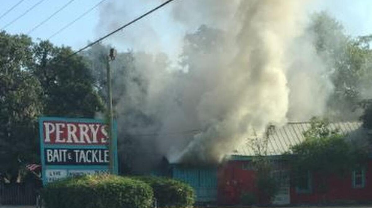 Smoke poured out of Perry’s Bait and Tackle Friday morning.