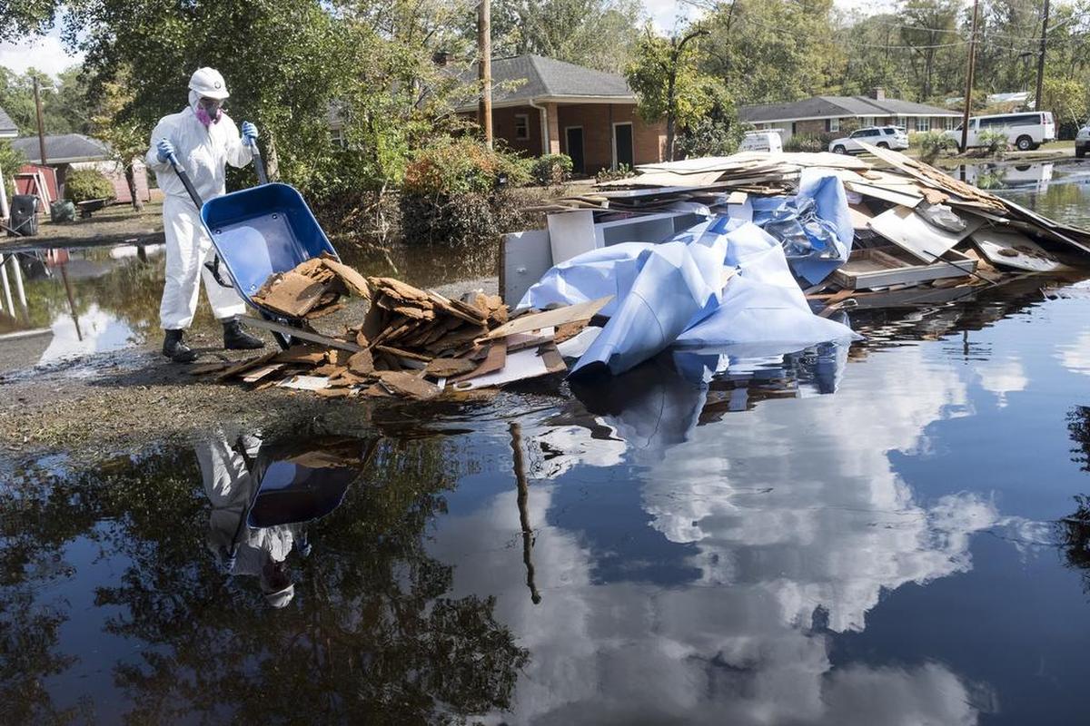 AmeriCorps volunteers from across the United States assist in mucking out the home of Joey Tyler on Sherwood Drive on Monday. The many volunteers that are helping with flood victims are organized under the Waccamaw VOAD (Voluntary Organizations Active in Disasters.) October 1 2018.