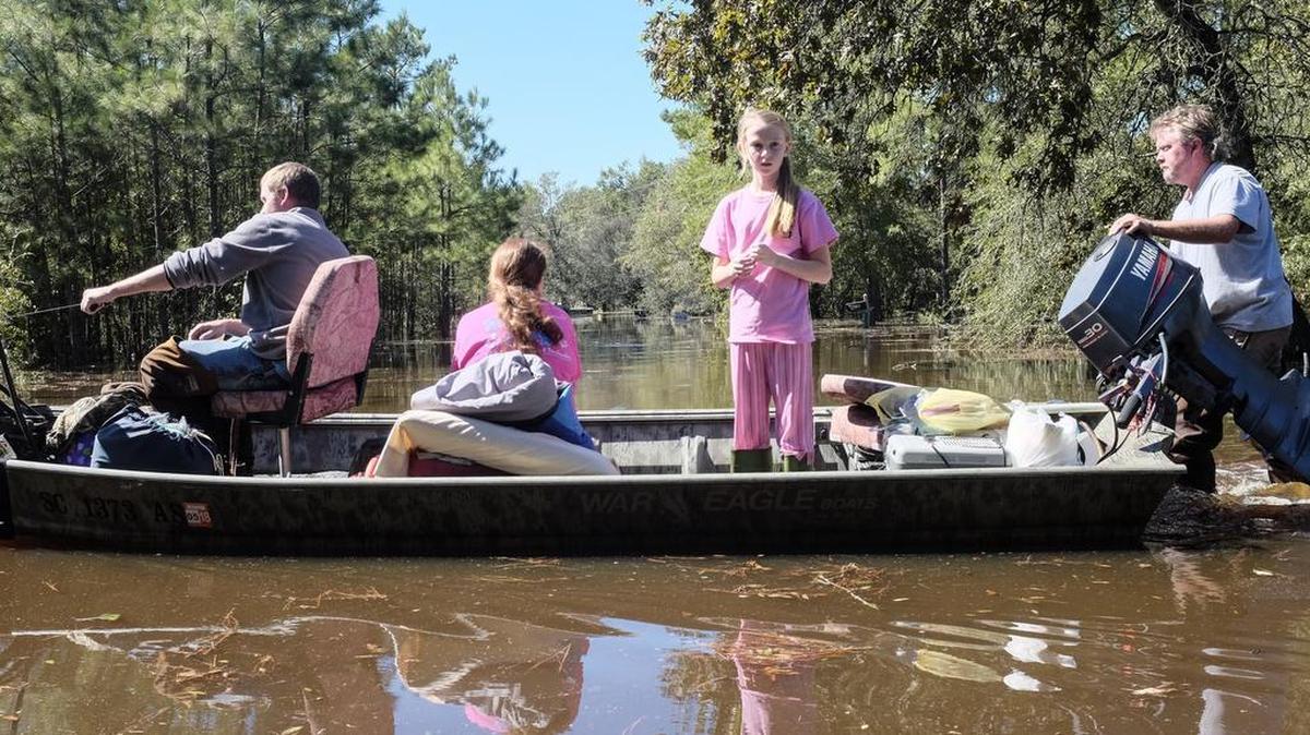 A family moves their belongings to higher ground in the Blue Savannah community. The Little Pee Dee river just North of Galivant's Ferry is flooding unexpectedly on Tuesday, forcing residents to make last minute evacuations. People in the Blue Savannah community say they had little warning and no one to help but each other as they tried to move belongings to higher ground.