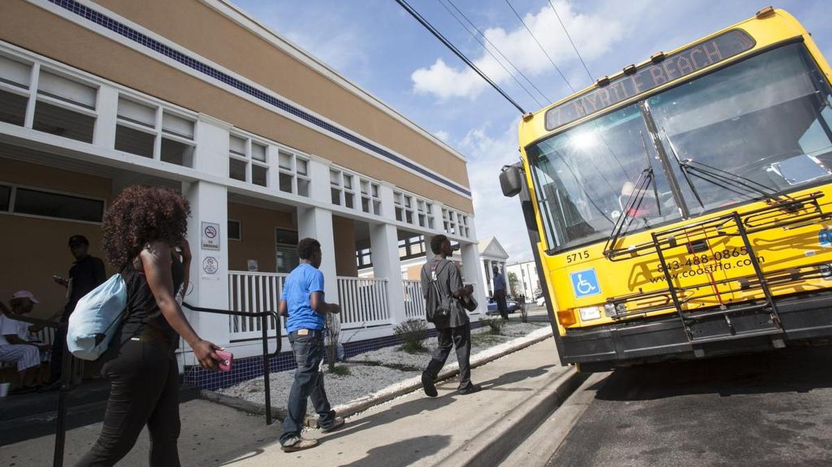 Riders board a Coast RTA bus as the Conway depot on Friday.