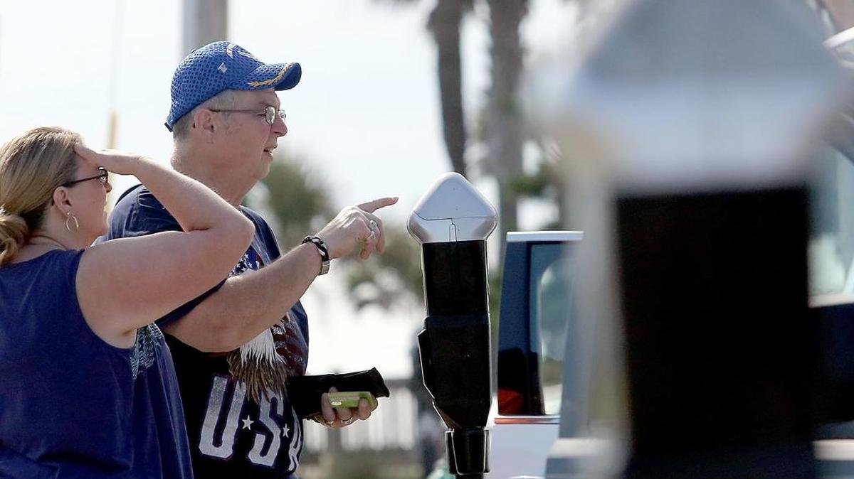 Visitors from Ohio figure out the parking meters off 8th Avenue North in Myrtle Beach on Tuesday, Aug. 23, 2016.