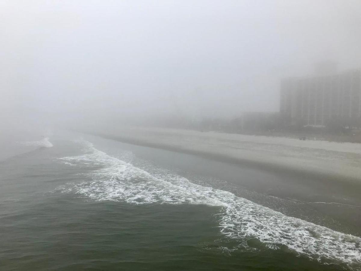 A picture taken from the pier at Pier 14 Restaurant show the Myrtle Beach Skywheel obscured by fog.