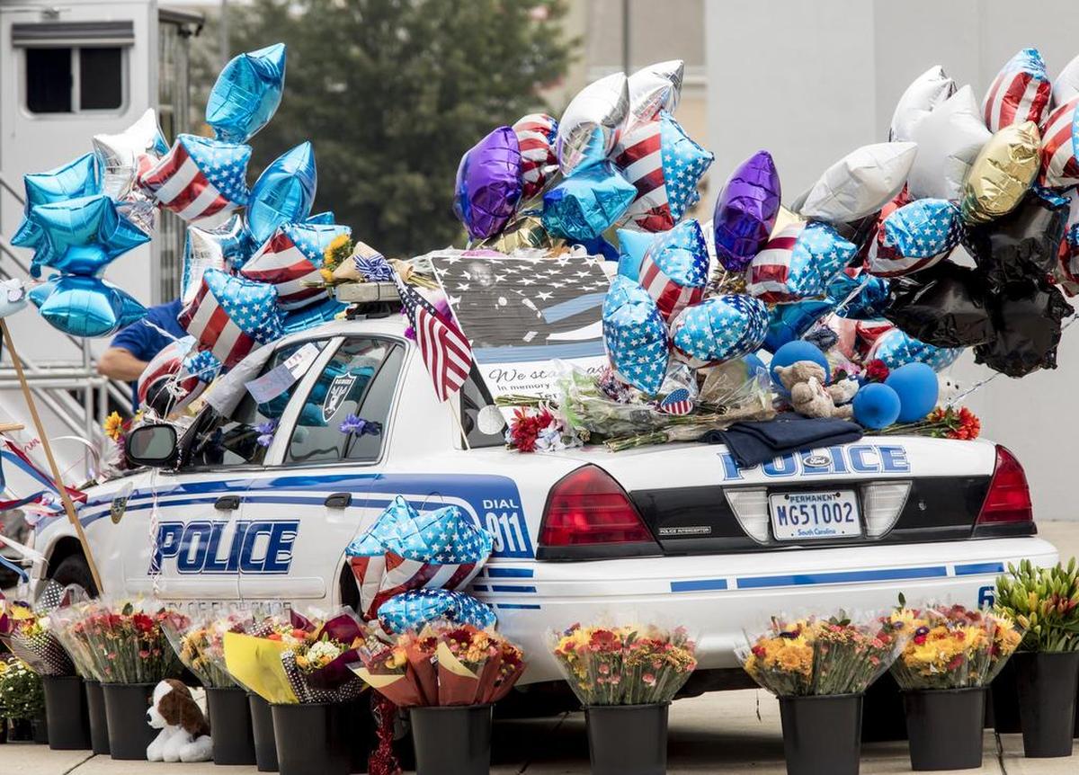 A Florence Police cruiser serves as a memorial outside the Florence center where funeral services are being held for held Monday for Sgt. Terrence Carraway. The Florence Police veteran officer was killed in an “ambush” style attack last Wednesday and six other officers were injured in the shooting. Fred Hopkins, 74, is charged with one count of murder and six counts of attempted murder for shooting and injuring six other officers. Oct. 8, 2018