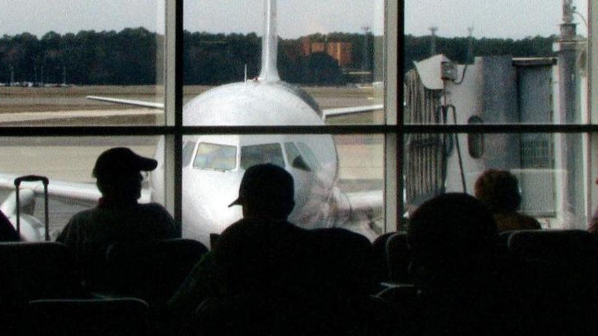 Waiting passengers watch as a plane arrives at Myrtle Beach International Airport.