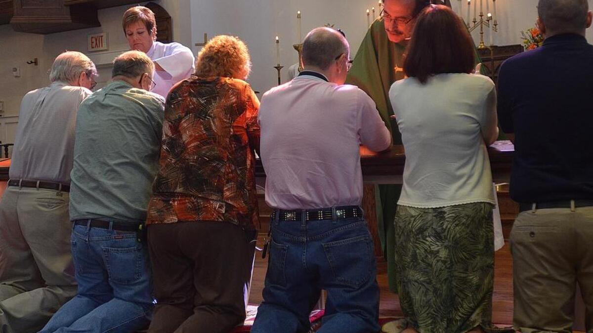 
The Rev. Reggie Corfield gives communion Sunday at St. Paul’s Church on Main Street in Conway. Flooding destroyed carpets and damaged the dry wall in several classrooms and in the administration building. St. Paul’s has been a fixture in the Conway area since the early 1900’s.
