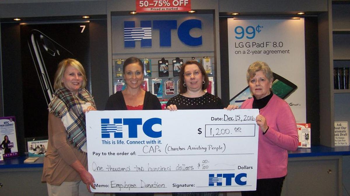 Lisa Martin (center) and Kimberly Hardwick (left), HTC Holiday Drive coordinators, present a $1,200 check from HTC employees to Donna Bodie, financial coordinator (right) Gail La Salle (far right), financial coordinator for CAPS.