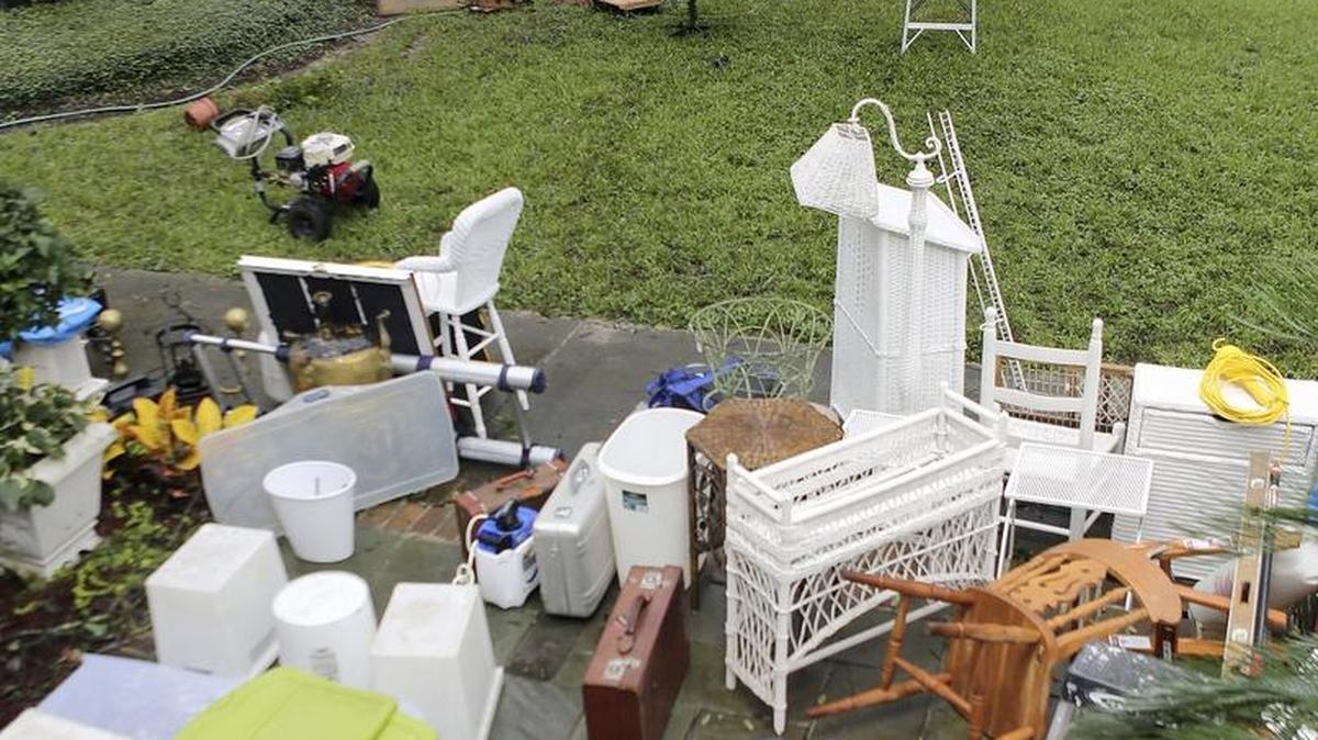 
Joan Rothrock's basement on Front Street in Georgetown held several feet of water until workers began pumping and sweeping on Monday, Oct. 5, 2015. Cleaning out as best they could, she joked they had no choice but to put a lot of basement stuff on the front lawn so it looks like a yard sale but the items will be cleaned and stored back in the basement.
