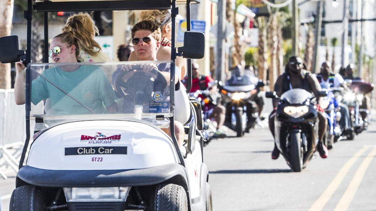 Golf carts flow along with bike traffic on Ocean Boulevard in this Sun News file photo. The vehicles soon won’t be allowed on one of the city’s busiest roads.