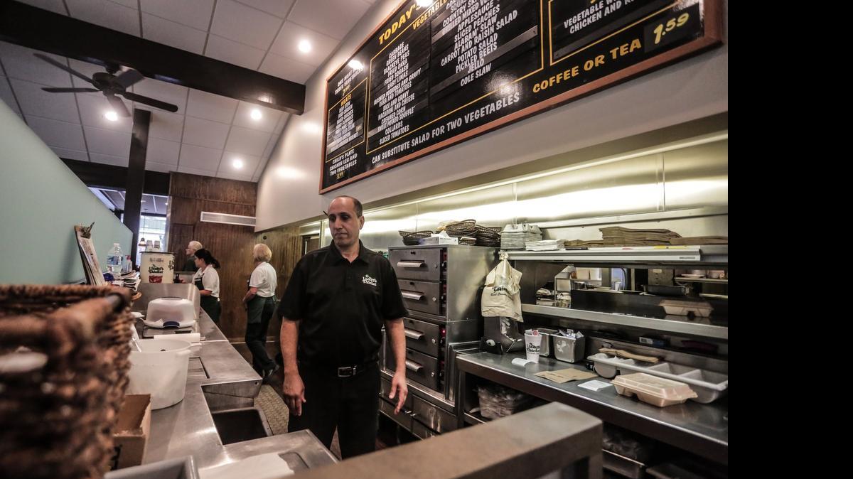 
Joe Raouf, general manager at Lizard's Thicket Beltline Boulevard restaurant, works the serving line Friday. Raouf has worked for Columbia-based, down home cooking chain for about a decade. 
