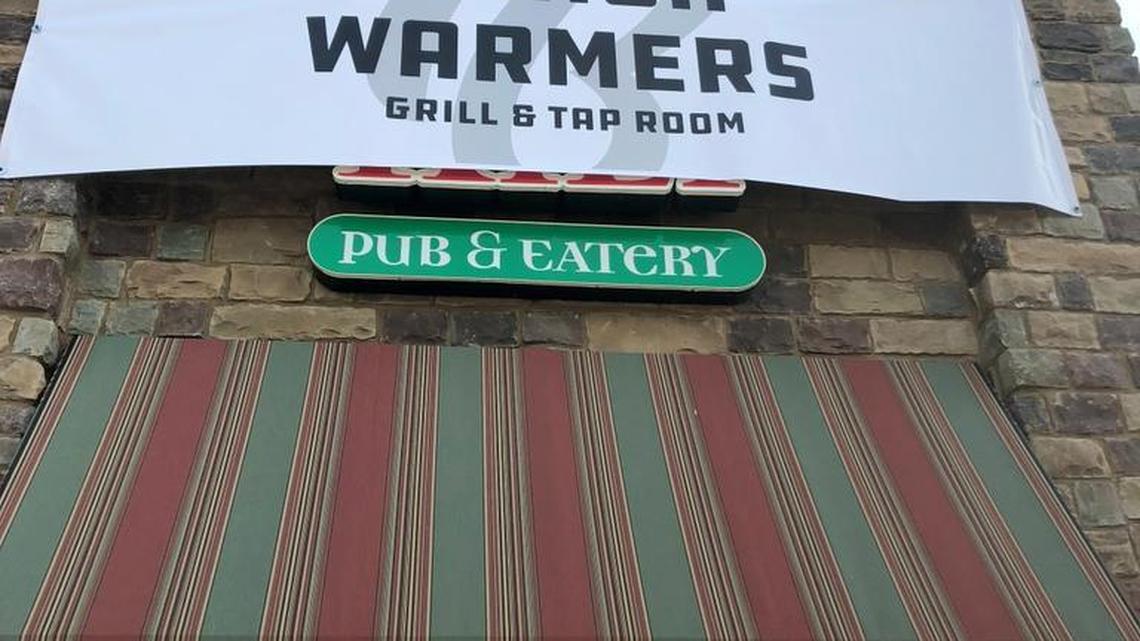 A temporary sign for the new sports bar and restaurant Bench Warmers covers up the Tilted Kilt sign on 21st Ave. North.