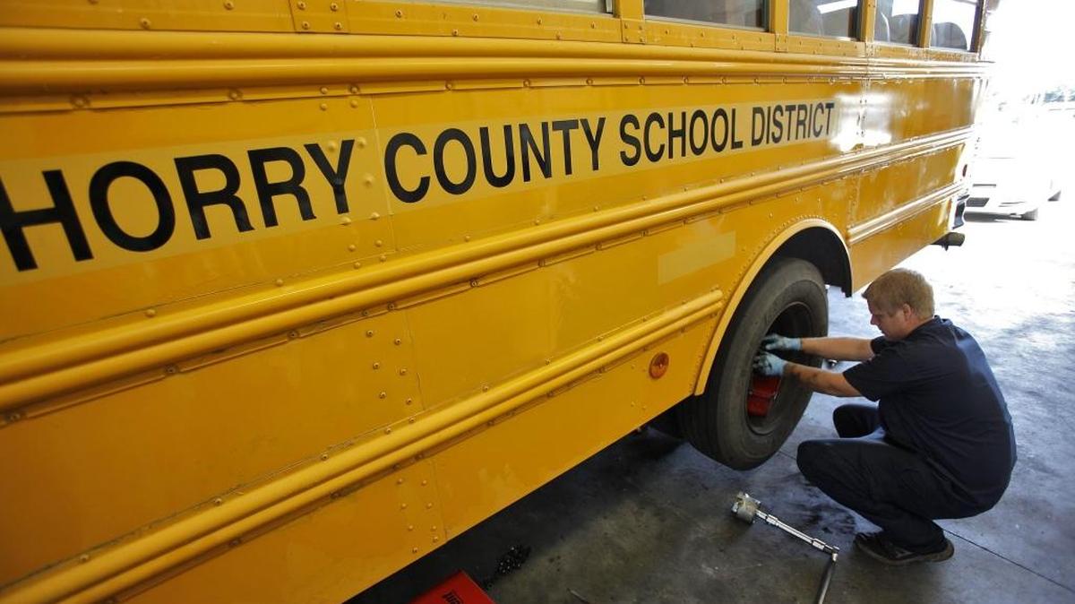 Mechanic Jonathon Jones works on the replacing brake pads on a school bus and doing annual maintenance in preparation for the first day of school at the Horry County School district maintenance department in Conway in this file photo.