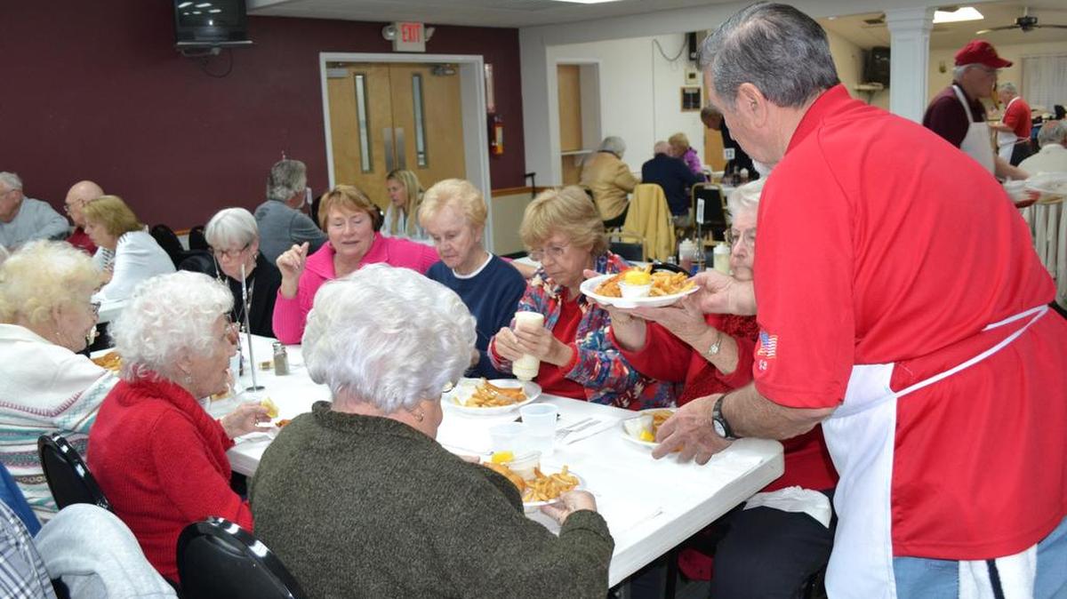 Jay Bertha serves Fish Fry dinners to those in attendance at a recent Lenten Fish Fry at VFW Calabash Post No. 7288.