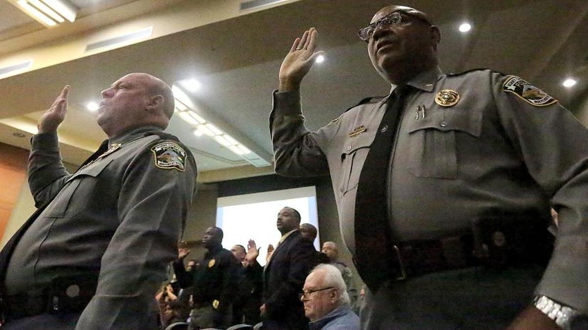 All the law enforcement officers stand to reaffirm their pledges during the swearing in ceremony for Horry County Police Chief Joseph Hill at the Horry County Courthouse on Sept. 30. Hill succeeds Saundra Rhodes, who left the post in May.