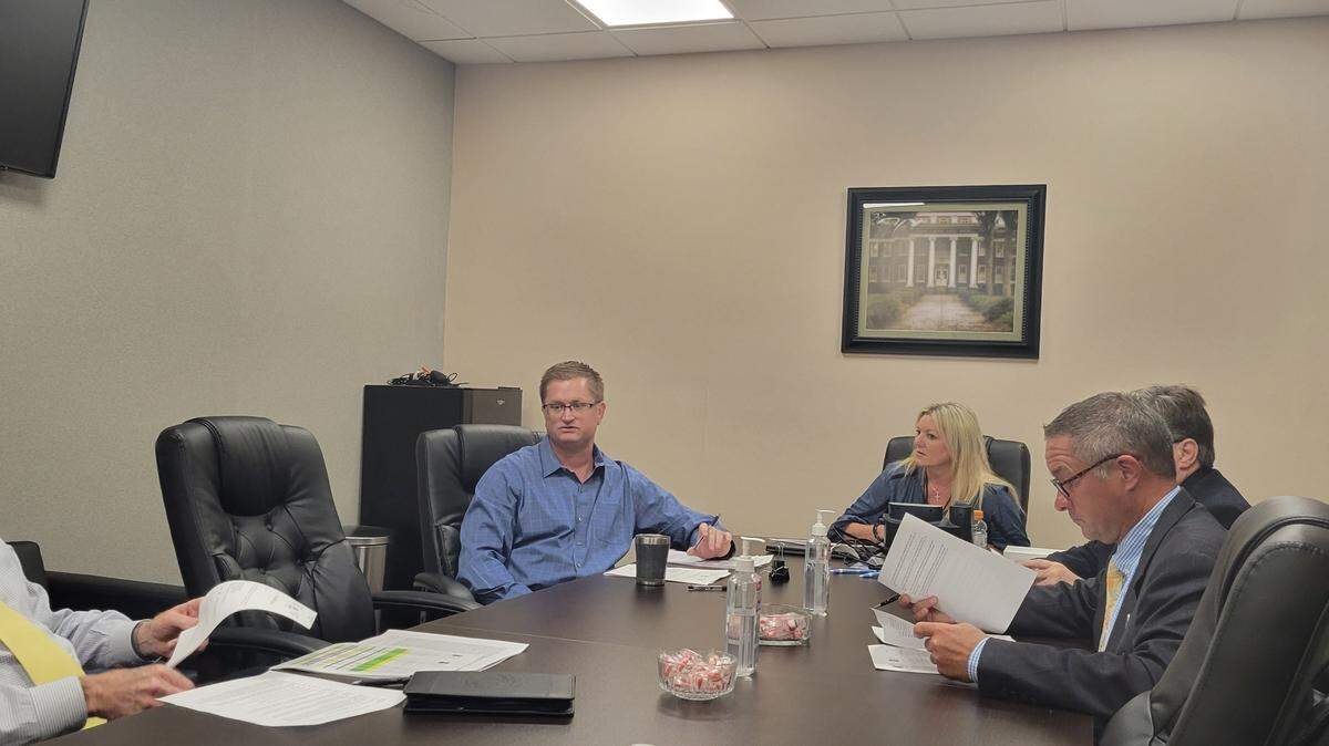 Horry County Sheriff Phillip Thompson, far left, 15th Circuit Solicitor Jimmy Richardson, right, and Treasurer Angie Jones, center, review changes to a policy regulating child-oriented businesses and sex offenders at a Monday, Aug. 8, 2022 meeting.