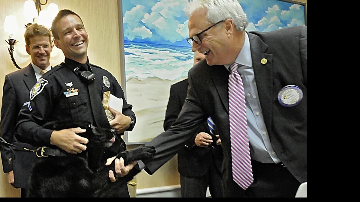
Winner of the Rotary Club of Myrtle Beach Officer Joe McGarry Memorial Police Officer of the Year Award-2014, PFC Chris Smith along with his canine partner, Alli are congratulated by Rotary Club of Myrtle Beach President Rigby Wilson. 
