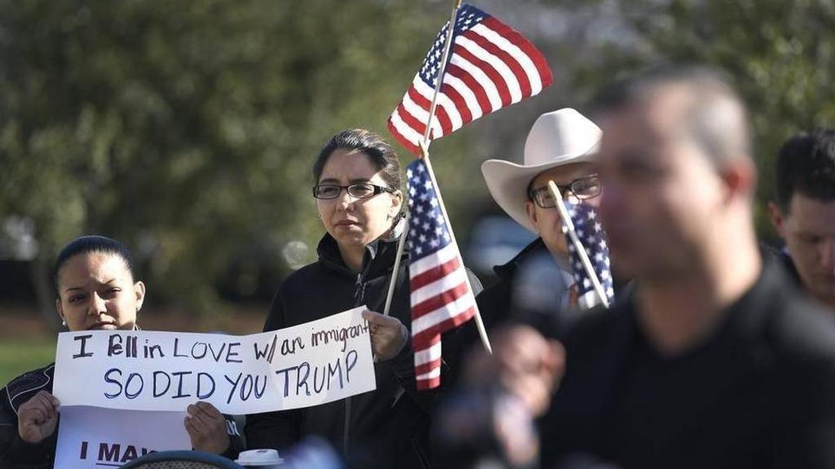 Alejandra Morales and Iris Navarro, left to right, were among about 20 Charlotte area residents, including immigrants, came together outside the Charlotte-Mecklenburg Government Center to protest raids by ICE agents in recent weeks on Friday, Feb. 10, 2017.
