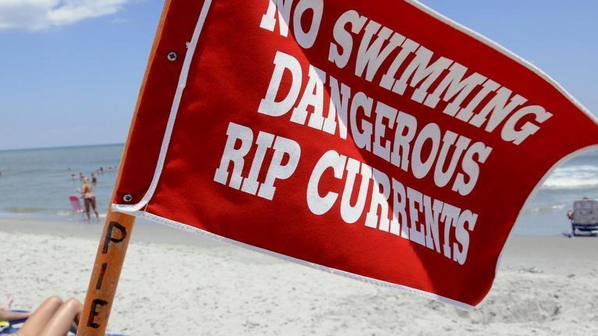 
Rip currents most typically form at low spots or breaks in sandbars, and also near structures such as groins, jetties and piers. This warning flag is posted at 2nd Avenue Pier in Myrtle Beach in 2013. Today, forecasters warn ocean swimmers to use caution.
