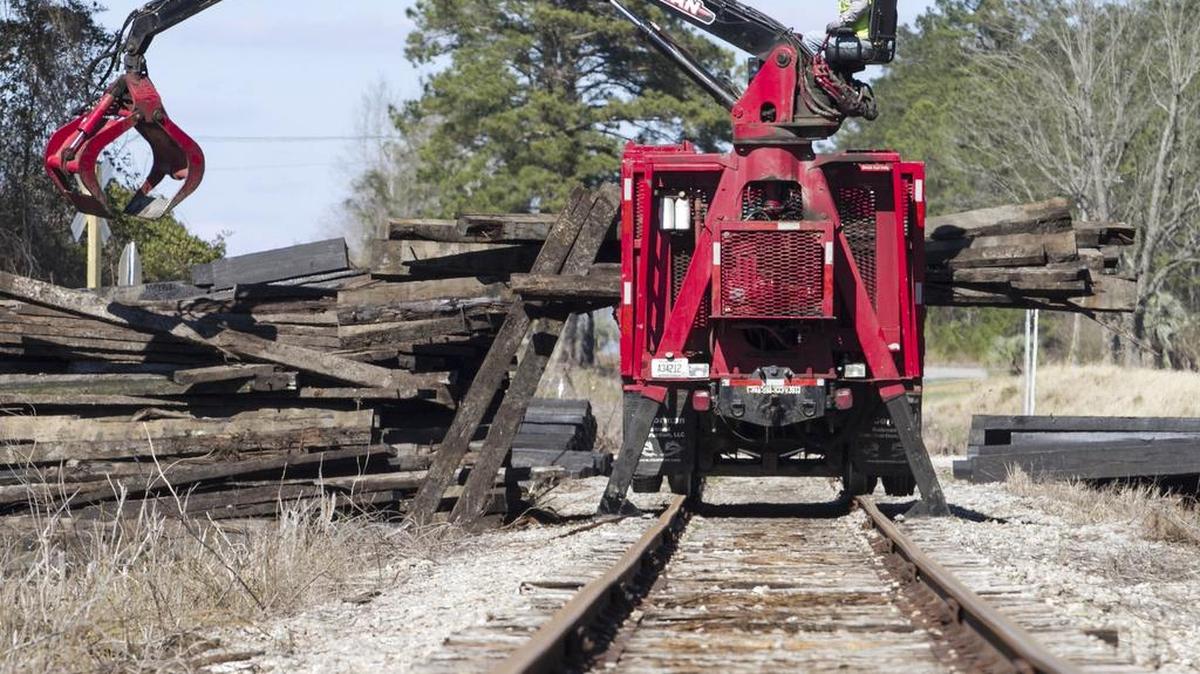 Crews from R.J. Corman work to repair a bridge over Bug Swamp near Loris on Friday. The train operator expects repairs to take a least a few more weeks and hopes to be operating by the first week of April.