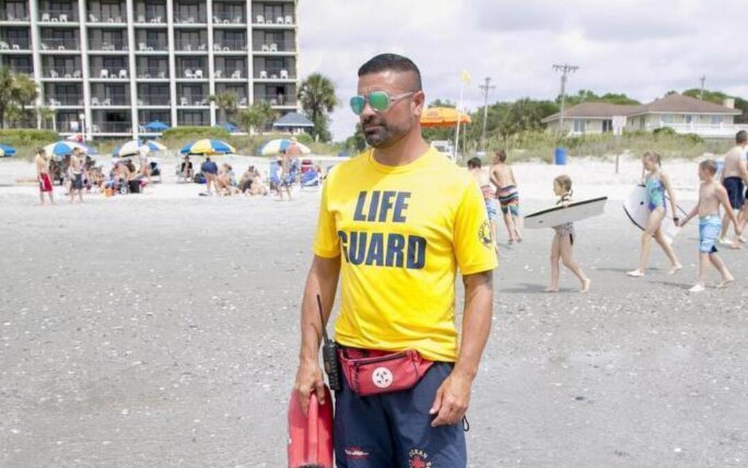 
Lifeguard David Starr with Gene’s Beach Services patrols the beach in July 2015 at 77th Ave. North in Myrtle Beach. 
