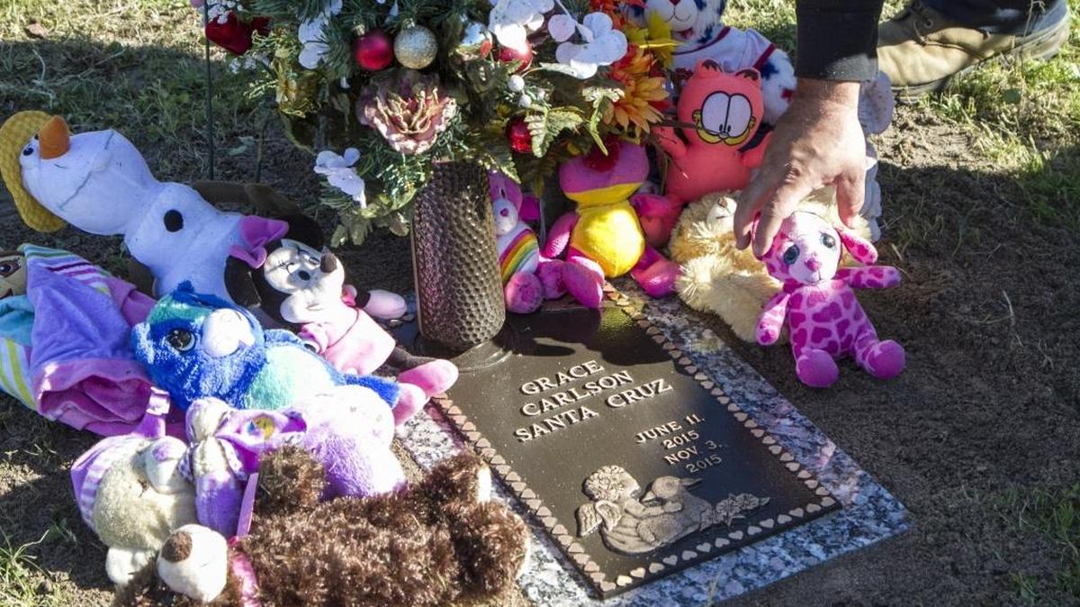 Jerrod Lovett, a maintenance worker at Hillcrest Cemetery, replaces a stuffed animal on the grave of Baby Grace Carlson Santa Cruz after helping to install her memorial stone in this file photo. The memorial was funded by the local community after the 5-month-old infant was found drowned in the Socastee swamp last November. Her mother, Sarah Lane Toney, is charged with homicide by child abuse.