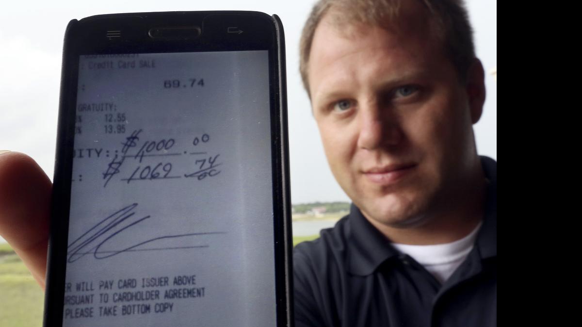 
Jesse Brown shows the phone shot of a receipt showing a $1,000 tip he received at Gulfstream Cafe. A waiter in the area for a decade, Brown has only worked at Gulfstream for less than two months. He said he was “in the weeds” the other night with a table of 10 and another table of six when he started waiting on a couple. The man asked about Brown's dream of owning a bed and breakfast and then promised to help him achieve his goal. After seeing the tip line filled out, Brown said he was overjoyed.
