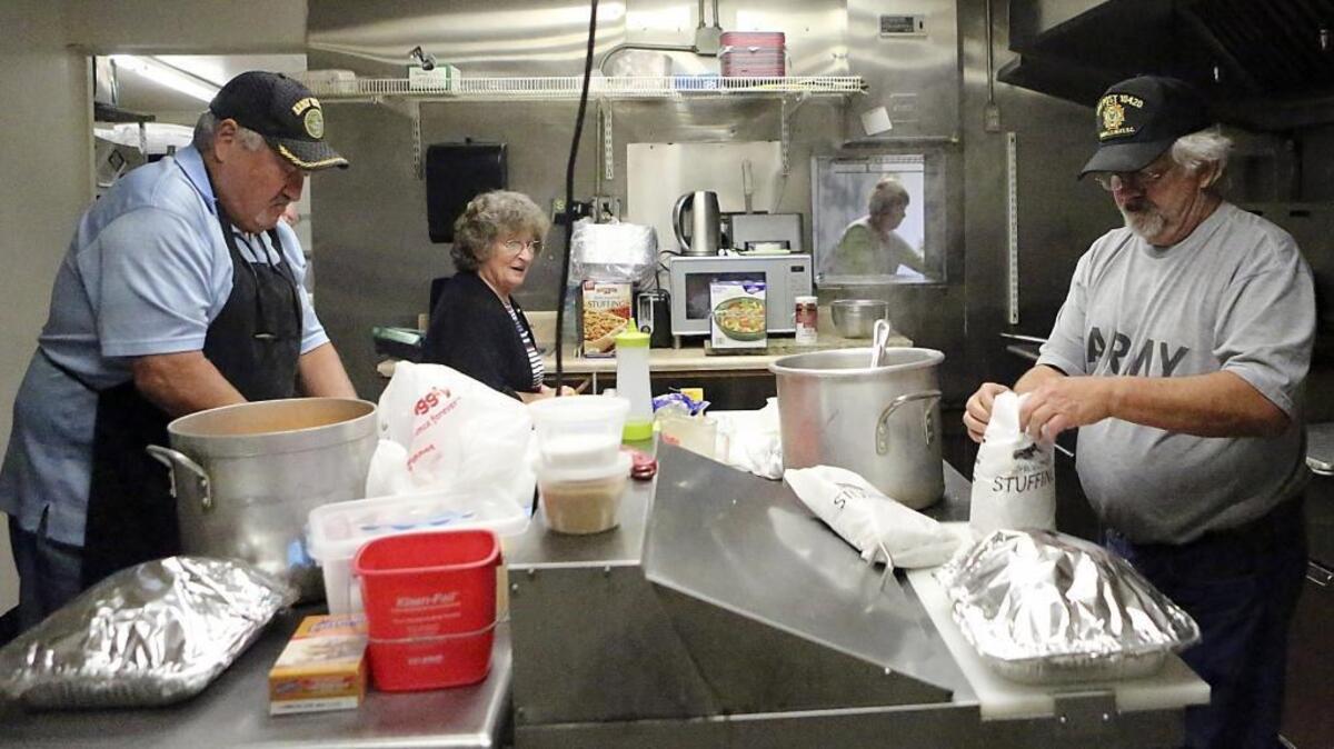 Philip Manna (left), Jan Raley (center) and Paul Roberts work in the kitchen preparing a Thanksgiving meal for more than 100 veterans at the Veterans of Foreign Wars Post 10420 in Murrells Inlet on Wednesday. The Thanksgiving feast will be served from noon to 4 p.m. Thursday at the post, 4359 U.S. 17 Bypass in Murrells Inlet.