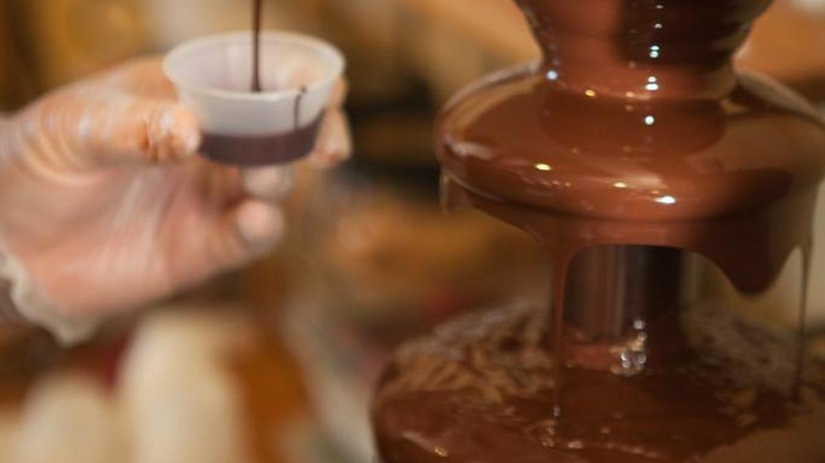 Bodega owner Stan Stephens scoops molten chocolate from a fountain in this file photo from the annual Conway Chocolate Walk, hosted by Conway Downtown Alive. Chocolate lovers from around the area participate and help promote small business and encourages folks to get out in their community.