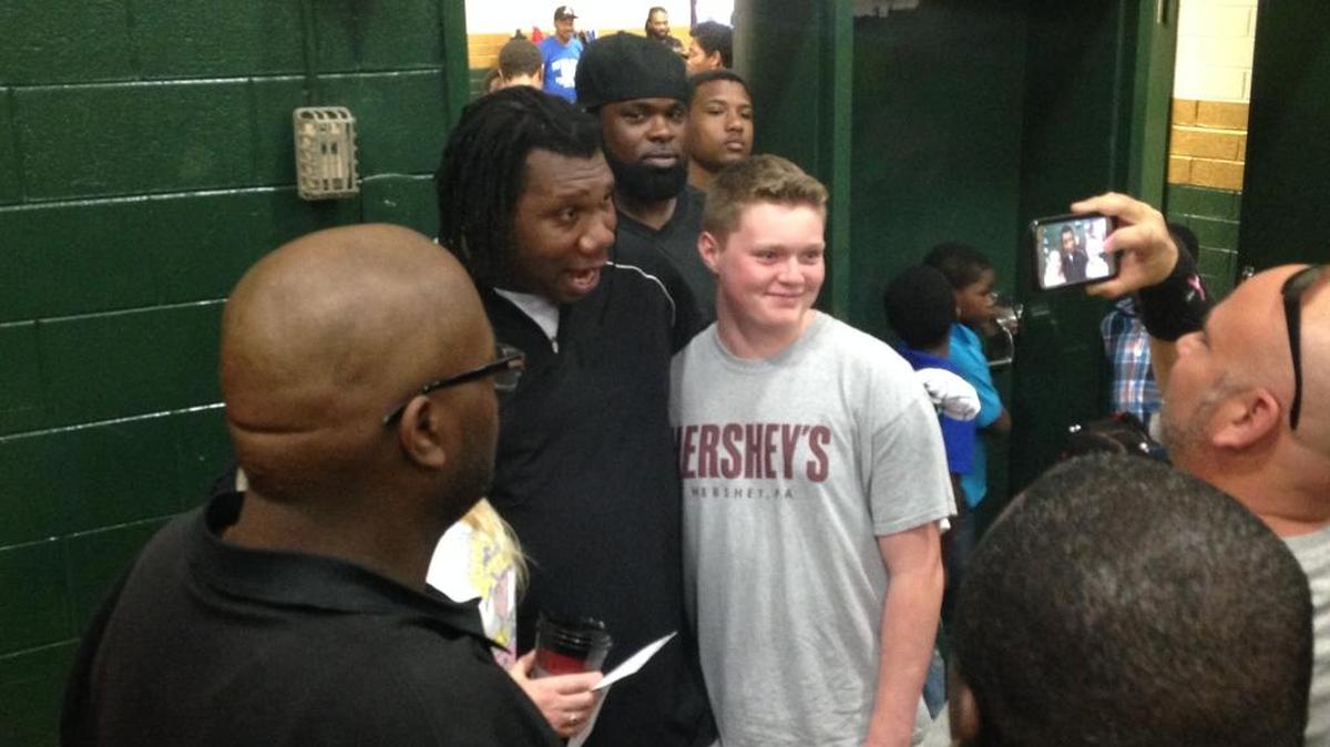 Legendary rapper KRS-One poses for a picture with a fan Saturday at Conway High School.