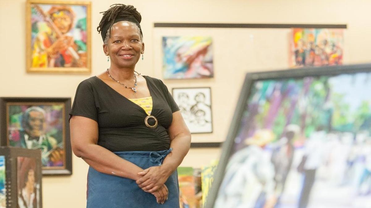 Alexandria Core stands in her new gallery Allys Art House In Inlet Square Mall center court.