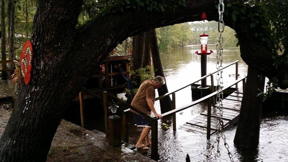
Garvin Huggins ventured onto the flooded dock at his son's home in Lee's Landing on Sunday, Oct. 4, 2015.

