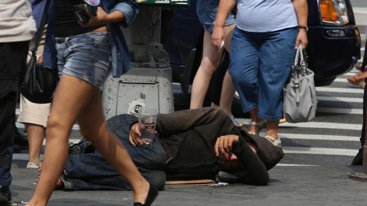 People walk past a homeless man asking for money on 14th Street in New York. One app dots a map with users’ images of homelessness in New York City. The apps, sites and social media accounts have spiraled out of a season of anxiety and frustration about rising homelessness in the nation’s biggest city. And they are igniting questions about technology, tolerance and citizenship in an age of crowdsourcing.