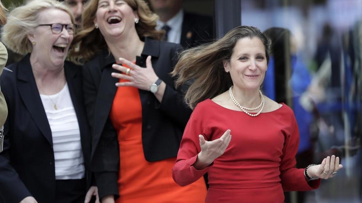Canada's Foreign Minister Chrystia Freeland, right, jokes as she is welcomed by Stephanie Bschorr, President of the Association of German Female Entrepreneurs, second from left, and Mona Kueppers, Chairwoman of the German Women's Council, left, before participating in the W20 Summit in Berlin.
