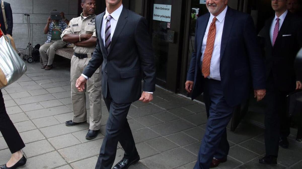 
Nigel Wright (left), former chief of staff to Prime Minister Stephen Harper, leaves the courthouse in Ottawa on Wednesday during a lunch break in his first day of testimony in the trial of former Conservative Senator Mike Duffy. 
